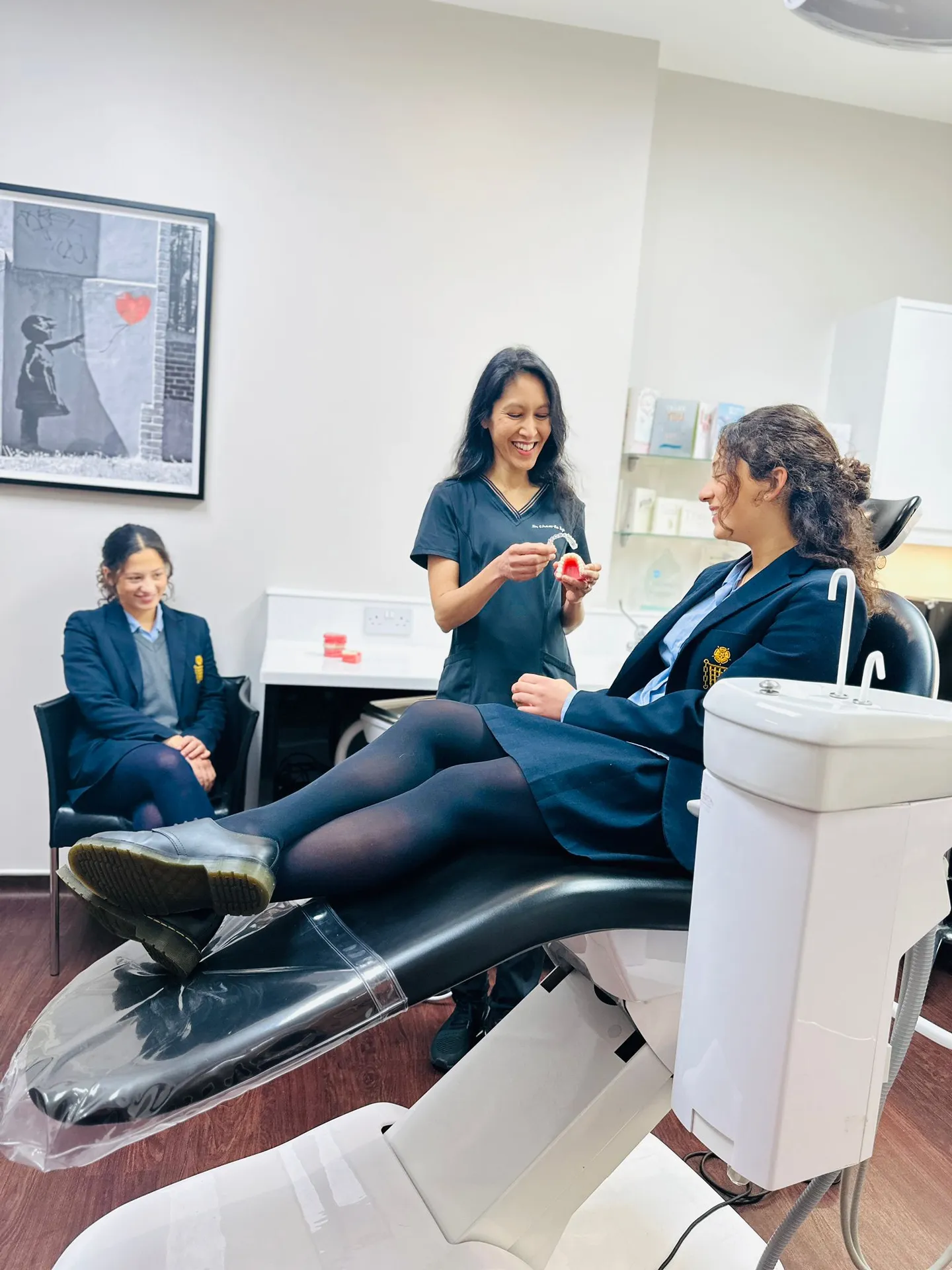 Dr Kyi fitting an aligner during a consultation at West London Orthodontist