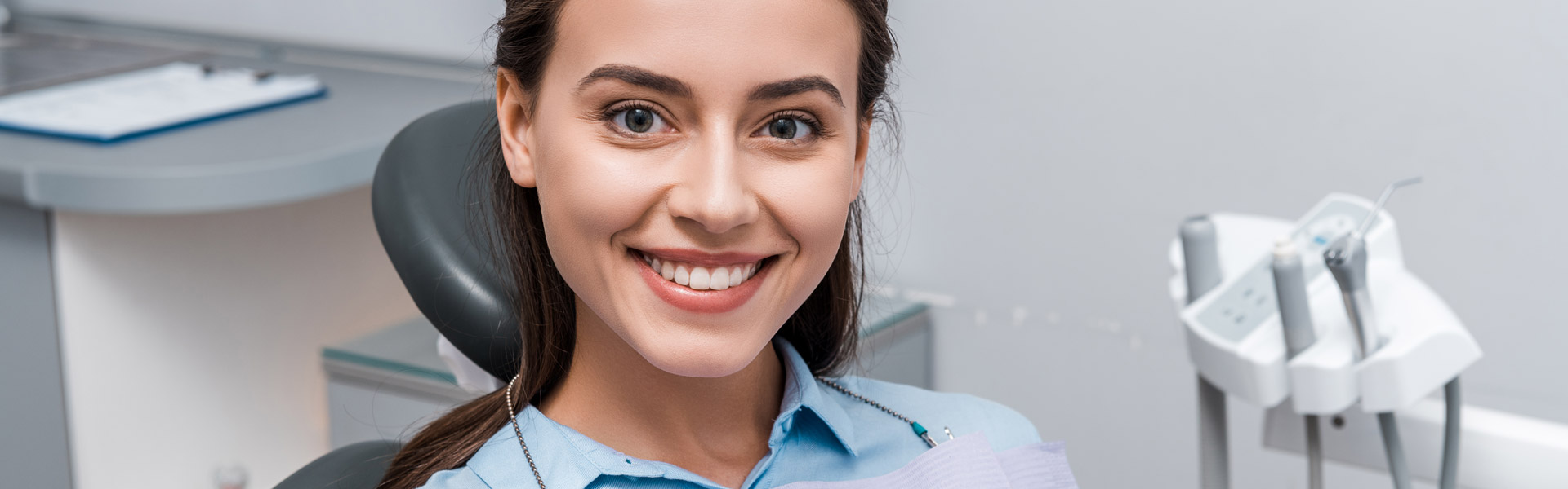 Smiling woman sitting comfortably in the dental clinic during an Invisalign consultation
