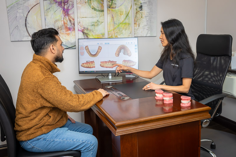 Dr Chaw-Su Kyi discussing an iTero scan with an adult Invisalign patient